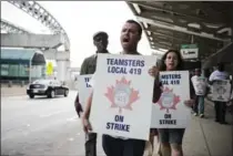  ?? CHRISTOPHE­R KATSAROV, THE CANADIAN PRESS ?? Striking workers are seen picketing at Pearson airport in Toronto on Friday. Union says Swissport is attempting to impose a three-year wage freeze.