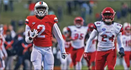  ??  ?? In this Nov. 10, 2018, file photo, Virginia’s Joe Reed (2) breaks away for a touchdown on the opening kickoff in the second half of an NCAA college football game against Liberty, in Charlottes­ville, Va. ZACK WAJSGRAS/THE DAILY PROGRESS VIA AP