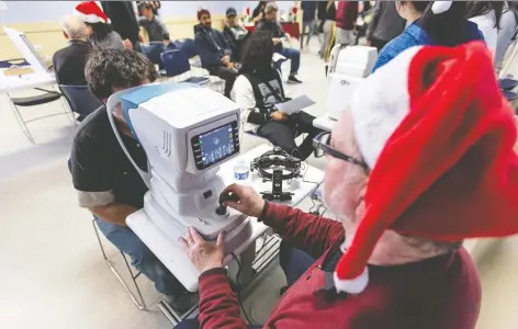  ?? PHOTOS: TOM JONES/THE EYEGLASSES PROJECT/THE CANADIAN PRESS ?? Salvation Army clients in the Downtown Eastside receive eye exams at a free clinic hosted by the Eyeglasses Project. New glasses help recipients function in day-to-day life, optometris­t Dr. Harbir Sian says.