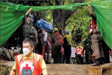  ?? AP/Chiang Rai Public Relations Office ?? One of the four boys rescued Sunday from a flooded undergroun­d cave in Mae Sai, Thailand, is carried to an ambulance by emergency workers for transport to a hospital.