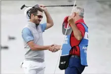  ?? ALEX GALLARDO — THE ASSOCIATED PRESS ?? Andrew Landry, left, celebrates with his caddie Terry Walker after winning The American Express golf tournament on the Stadium Course at PGA West in La Quinta, Calif., Sunday.