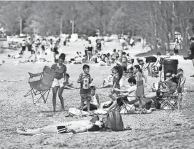  ?? ALEX COOPER/UTICA OBSERVER-DISPATCH ?? Guests visit the beach during Memorial Day weekend on May 23, 2020, at Sylvan Beach.