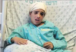  ?? GPO/GETTY IMAGES ?? Thirteen-year-old Ahmed Manasra, sits in his hospital bed at the Hadassah Medical Center on Thursday. Palestinia­n President Mahmoud Abbas ignited an uproar after falsely claiming that Israel had “executed” the boy.