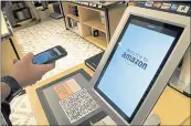  ??  ?? Daniel Thorpe, of Hoboken, New Jersey, uses the Amazon app to pay for his purchase at the Amazon 4-star store. The 4-star store does not accept cash.