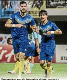  ??  ?? Penangites regain bragging rights: Penang’s Al-Hafiz Harun (right) rejoicing with Endrick Santos after scoring in the 4-1 win over Kelantan United that earned the Panthers their first Premier League title.