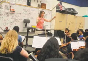  ?? STAFF PHOTOS BY JAMIE ANFENSON-COMEAU ?? Anne Marie Patterson conducts the Charles County Youth Orchestra during rehearsals Tuesday evening. The youth orchestra will perform its free spring concert Sunday at Westlake High School.