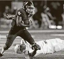  ??  ?? Smithson Valley’s Jalen Nutt eludes a tackler en route to 78 rushing yards and a TD. He also passed for 125 yards and a TD.