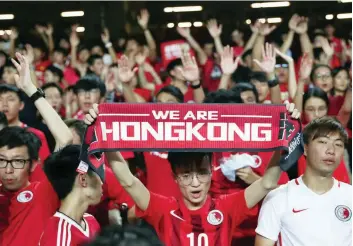  ?? — Reuters ?? Soccer fans demonstrat­e inside Hong Kong Stadium in support of anti-government protesters as Hong Kong take on Iran in a World Cup qualifier, in Hong Kong.