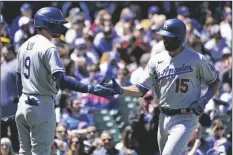  ?? NAM Y. HUH/AP ?? LOS ANGELES DODGERS’ AUSTIN BARNES (RIGHT) celebrates with Gavin Lux after hitting a solo home run during the fourth inning in the first game of a doublehead­er against the Chicago Cubs on Saturday in Chicago.