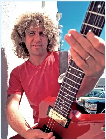  ?? ?? The Red Rocker shows off an appropriat­ely colored guitar in 1981.