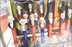  ??  ?? Pez dispensers from the U.S. Presidents Series from Shawn Peterson’s personal collection on display at the Pez Visitor Center in Orange.