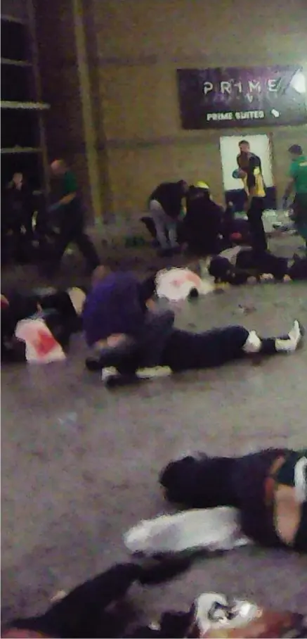  ??  ?? The terrible aftermath: Just moments after the explosion, this was the horrific scene in the foyer of the Manchester Arena, with victims, blood and debris strewn over the floor while police, paramedics and concertgoe­rs tried to help the wounded