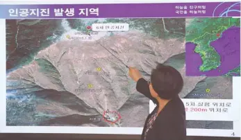  ?? — AFP ?? Lee Mi-Seon, a director of the National Earthquake and Volcano Centre, shows a map of a North Korean location during a briefing about the “artificial earthquake” in North Korea, at the Korea Meteorolog­ical Administra­tion in Seoul on Sunday.