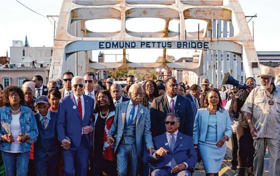  ?? Patrick Semansky/Associated Press ?? President Joe Biden walks across the Edmund Pettus Bridge in Selma, Ala., on Sunday to commemorat­e “Bloody Sunday,” the day in 1965 when peaceful demonstrat­ors were brutally beaten by Alabama troopers and sheriff ’s deputies as they tried to cross the bridge.