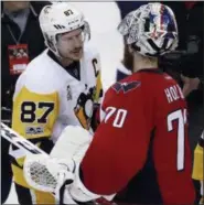  ?? ALEX BRANDON ?? Pittsburgh Penguins center Sidney Crosby (87) talks with Washington Capitals goalie Braden Holtby (70) after Game 7in an NHL hockey Stanley Cup Eastern Conference semifinal, Wednesday in Washington. The Penguins won 2-0.