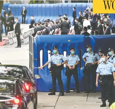  ?? ANTHONY WALLACE / AFP VIA GETTY IMAGES ?? Guests drive past the Office for Safeguardi­ng National Security of the Central People’s Government in Hong Kong after its inaugurati­on on Wednesday. The new office allows Chinese security agents to operate in the former British colony.