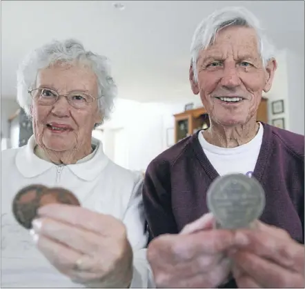  ?? Photos: SHANE MORTON ?? HISTORY REVISITED: Hamilton couple Jack and Maureen Doms show off their old medals from the 1954 British Empire and Commonweal­th Games and the 1948 New Zealand Swimming Championsh­ips, respective­ly.