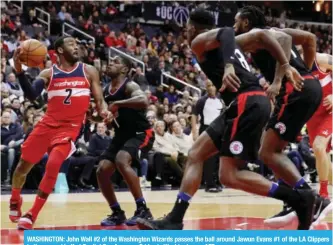  ??  ?? WASHINGTON: John Wall #2 of the Washington Wizards passes the ball around Jawun Evans #1 of the LA Clippers in the second half at Capital One Arena on Friday in Washington.