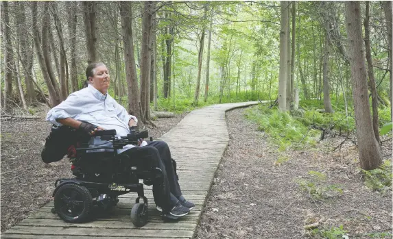  ?? TONY CALDWELL ?? Mike Nemesvary, a quadripleg­ic, enjoys the Baxter Conservati­on Area along the Rideau River. Nemesvary is part of a group working to improve inclusive design.