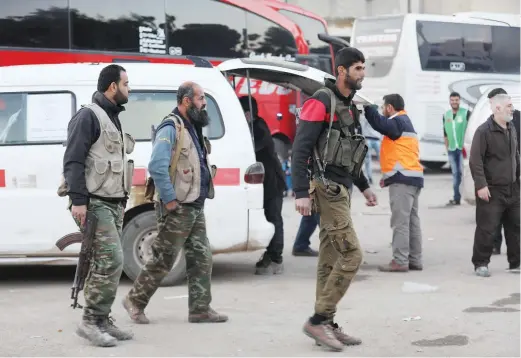  ??  ?? Civilians and fighters arrive in Qalaat Al-Madiq after being evacuated from the Eastern Ghouta town of Douma. (AFP)