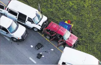  ?? Jay Janner ?? The Associated Press Officials investigat­e near a vehicle, center, where a suspect in the deadly Austin bombings blew himself up as authoritie­s closed in on him Wednesday in Round Rock, Texas.