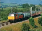  ??  ?? Class 86/2 No. 86241 Glenfiddic­h speeds down Shap near Scout Green with a southbound mail stowage train on July 18, 1994. It was withdrawn by EWS in January 2000 and scrapped two years' later.