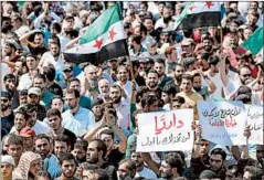  ?? OMAR HAJ KADOUR/GETTY-AFP ?? Syrian protesters decry the regime and its ally Russia in rebel-held Idlib on Friday.