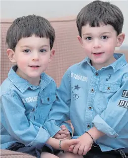  ??  ?? Threeyear-old James, left, and Alfie Harkness who wear special ID bands so that their family can tell which is which