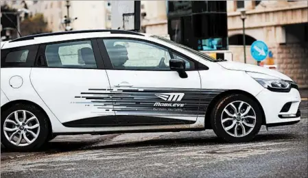  ?? ATEF SAFADI/EPA ?? A Mobileye employee drives one of the high-tech company’s vehicles at its Jerusalem headquarte­rs. Mobileye specialize­s in driver-assistance systems.
