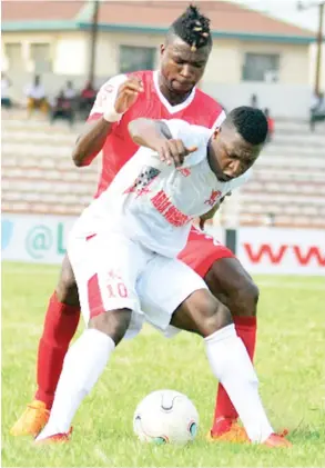  ??  ?? Abia Warriors’ Ndifreke Effiong (10) contests for the ball with James Odeh (23) of Heartland during a recent league match