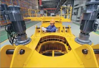  ?? XIE SHANGGUO / FOR CHINA DAILY ?? An employee works on the production line of a machinery manufactur­er in Huzhou, Zhejiang province.