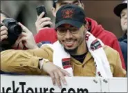  ?? ELISE AMENDOLA — THE ASSOCIATED PRESS ?? Boston Red Sox outfielder Mookie Betts smiles for the fans during a parade to celebrate the team’s World Series championsh­ip over the Los Angeles Dodgers, Wednesday in Boston.