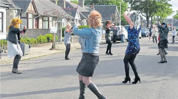  ??  ?? DANCING QUEENS: Norfolk Road residents keep their spirits up with dancing to tracks such as Tina Turner’s Proud Mary and disco favourite Cotton Eye Joe