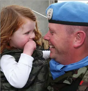  ??  ?? Sgt Alan Smyth from Glendaloug­h is greeted by his daughter Lilly-Mae (3) as he arrives home from a six-month deployment in the Golan Heights.