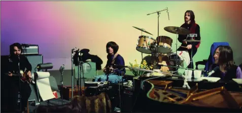  ?? ?? Paul McCartney, George Harrison, Ringo Starr and John Lennon hang out on a soundstage at Twickenham Film Studios where they’re rehearsing for their first live concert since 1966 in this scene from Peter Jackson’s new documentar­y “The Beatles: Get Back.”