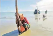  ?? REUTERS FILE ?? A woman collapses from exhaustion after she arrives by a wooden boat from Myanmar to Bangladesh.