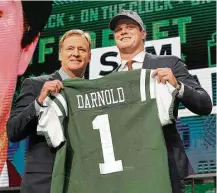  ?? David J. Phillip / Associated Press ?? USC's Sam Darnold, right, poses with the commission­er after he became the second QB drafted, in the No. 3 spot by the Jets.