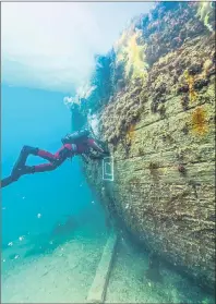  ?? THIERRY BOYER/PARKS CANADA IMAGE ?? An archaeolog­ist collects samples underwater from HMS Erebus.