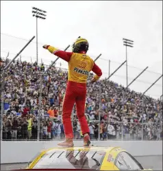  ?? JEFF ROBERSON/ASSOCIATED PRESS ?? Joey Logano celebrates after delivering a much-needed win for Team Penske in the NASCAR Cup Series debut at World Wide Technology Raceway in Madison, Ill., on Sunday.