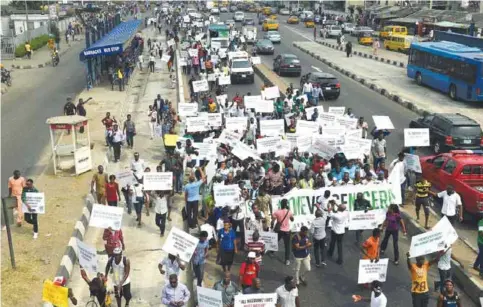  ??  ?? LAGOS: Protesters hold placards and banners during an anti-government demonstrat­ion on Feb 6, 2017. — AFP