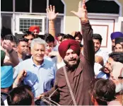  ?? PHOTO: PTI ?? Punjab Cabinet minister Navjot Singh Sidhu ( with dhol) and Congress state chief Sunil Jakhar ( behind him) celebrate with other party leaders after winning the Parliament­ary bypoll, in Gurdaspur on Sunday