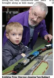  ??  ?? Exhibitor Peter Shermer showing Tom Hubbart his train display.