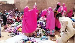  ?? Pic by Maryam Ahmadu-Suka ?? Members of Sisters of Jannah distributi­ng clothes and various food items to about
100 widows and orphans in Kaduna State.