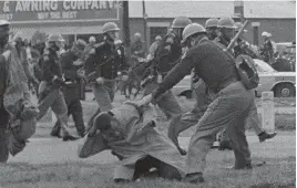  ?? AP FILE PHOTO ?? FIGHT FOR RIGHTS: John Lewis is beaten by a state trooper in Selma, Ala., during a civil rights voting march in March 1965. Now a congressma­n, Lewis has lashed out at Donald Trump.
