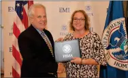  ?? SUBMITTED PHOTO ?? Michael J. Sharon, FEMA Emergency Management Institute Deputy Superinten­dent, congratula­tes Amy Amer, who completed FEMA’s Master Public Informatio­n Officer Program.