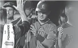  ?? PHOTOS BY RON CHENOY/USA TODAY SPORTS ?? The Diamondbac­ks’ Josh Rojas celebrates after scoring against the Rockies on Monday night.