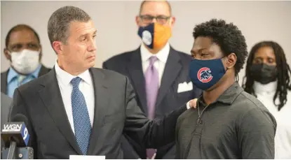  ?? ANTHONY VAZQUEZ/SUN-TIMES ?? Attorney Antonio Romanucci (left) speaks Tuesday about Rashawn Lindsey’s story of being stopped by police and searched without reason in announcing a class-action lawsuit at Romanucci & Blandin law offices in the Loop.