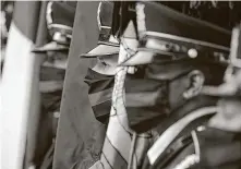  ?? Elizabeth Conley / Staff photograph­er ?? Members of HPD’s Honor Guard stand at attention before the three-hour funeral service, which was streamed online.