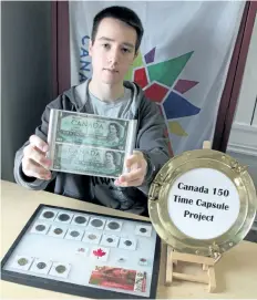  ?? PORT COLBORNE HISTORICAL AND MARINE MUSEUM PHOTO ?? Port Colborne Historical and Marine Museum research assistant Quintin Keddy, a co- op student from Lakeshore Catholic High School, holds two 1967 Centennial series Canadian one- dollar bills he donated to be included in a Canada 150 time capsule that...