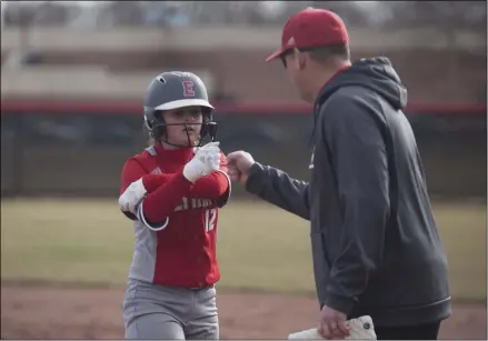  ?? JEN FORBUS — FOR THE MORNING JOURNAL ?? Elyria’s Mallory Phares gets a fist bump from first base coach John Wallace on April 2, 2019.